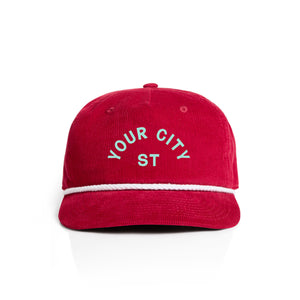 Customizable red corduroy cap with 'YOUR CITY STATE' text on a white background