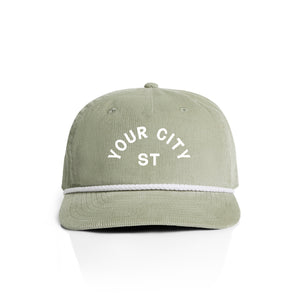Customizable green corduroy cap with 'YOUR CITY STATE' text on a white background