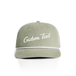 Pistachio green corduroy cap with 'Custom Text' on a white background