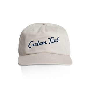 Customizable off white cap with 'Custom Text' in navy blue on a white background